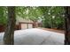 Traditional brick home with a two-car garage and a long driveway, surrounded by lush greenery at 5190 Southlake Dr, Alpharetta, GA 30005
