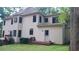 Spacious two-story home with deck, lush green lawn and mature trees, creates a serene backyard oasis at 5190 Southlake Dr, Alpharetta, GA 30005