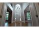 Grand foyer featuring a high ceiling, arched window, and elegant lighting fixture at 5190 Southlake Dr, Alpharetta, GA 30005