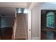 Welcoming foyer featuring hardwood floors, stairs, and an archway leading to another room at 5190 Southlake Dr, Alpharetta, GA 30005