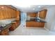 Well-lit kitchen featuring an island cooktop, lots of wooden cabinets, and a stainless double oven at 5190 Southlake Dr, Alpharetta, GA 30005