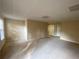 Bright living room with natural light, beige carpet, white trim and neutral walls provides a cozy atmosphere at 5190 Southlake Dr, Alpharetta, GA 30005