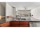 Open-concept kitchen island with granite counters and stainless appliances overlooking the well-lit living room at 1376 Parkview Ne Ln, Atlanta, GA 30324