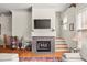 Cozy living room featuring a fireplace, tv, staircase, and hardwood floors, offering a comfortable retreat at 1376 Parkview Ne Ln, Atlanta, GA 30324