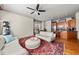 Open-concept living room flowing into a modern kitchen, featuring hardwood floors, fan, and stylish decor at 1376 Parkview Ne Ln, Atlanta, GA 30324
