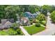 A high angle view of the charming home, manicured lawn and mature landscaping at 176 Rockyford Ne Rd, Atlanta, GA 30317