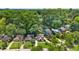 An aerial view of a house shows mature landscaping, a street and several neighboring homes at 176 Rockyford Ne Rd, Atlanta, GA 30317