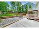 Well-maintained backyard with a patio, play set, and tiered garden beds for outdoor enjoyment at 176 Rockyford Ne Rd, Atlanta, GA 30317