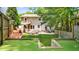 Beautiful backyard featuring a putting green, playset, and mature trees, perfect for outdoor activities and enjoyment at 176 Rockyford Ne Rd, Atlanta, GA 30317