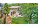 Large backyard with a two-story deck, playset, and ample green space for recreation and relaxation at 176 Rockyford Ne Rd, Atlanta, GA 30317