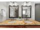 Bathroom features double sinks with granite counters and framed mirrors, with a view to the bathtub at 176 Rockyford Ne Rd, Atlanta, GA 30317
