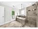 Stunning bathroom featuring a separate shower and bathtub plus access to a private outdoor deck at 176 Rockyford Ne Rd, Atlanta, GA 30317