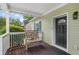 Charming front porch with dark-stained wood, white railings, and a cozy swinging bench at 176 Rockyford Ne Rd, Atlanta, GA 30317