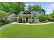 Charming home featuring a well-manicured lawn, inviting front porch, and classic architectural details at 176 Rockyford Ne Rd, Atlanta, GA 30317