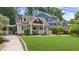 Charming home featuring dormer windows, a well-manicured lawn, and convenient carport at 176 Rockyford Ne Rd, Atlanta, GA 30317