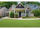 Charming home featuring a well-manicured lawn, inviting front porch, and classic architectural details at 176 Rockyford Ne Rd, Atlanta, GA 30317