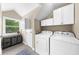 Laundry room with washer, dryer, storage cabinets, and folding area at 176 Rockyford Ne Rd, Atlanta, GA 30317