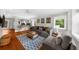 Bright living room with hardwood floors, a comfortable gray sofa, and plenty of natural light at 176 Rockyford Ne Rd, Atlanta, GA 30317