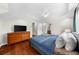 Hardwood floors add a touch of elegance to the main bedroom with tray ceilings and a large window at 176 Rockyford Ne Rd, Atlanta, GA 30317