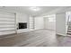 Finished basement with vinyl floors, a white brick fireplace, and built-in shelving at 3611 Radcliffe Blvd, Decatur, GA 30034