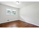 This bedroom features hardwood floors and a window overlooking the yard at 3611 Radcliffe Blvd, Decatur, GA 30034