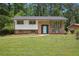 Charming brick home featuring a well-manicured lawn, classic architectural design, and a welcoming light blue front door at 3611 Radcliffe Blvd, Decatur, GA 30034
