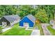 An aerial view showcasing two modern homes, one with black siding and another with blue siding, each with a pristine lawn at 587 Woods Nw Dr, Atlanta, GA 30318