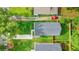 Aerial view of a house, showcasing its well-maintained lawn, modern roof, and proximity to lush greenery at 587 Woods Nw Dr, Atlanta, GA 30318
