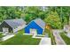 An aerial view showcasing two modern homes, one with black siding and another with blue siding, each with a pristine lawn at 587 Woods Nw Dr, Atlanta, GA 30318
