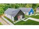 An aerial view showcases two modern homes, one with black siding and another with blue siding, each with a pristine lawn at 587 Woods Nw Dr, Atlanta, GA 30318