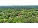 Aerial shot showing the home surrounded by dense, mature trees, with the city skyline visible in the distance at 587 Woods Nw Dr, Atlanta, GA 30318