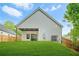 Exterior view of the back of the home featuring a covered patio and spacious backyard at 587 Woods Nw Dr, Atlanta, GA 30318