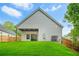 Exterior view of the back of the home featuring a covered patio and spacious backyard at 587 Woods Nw Dr, Atlanta, GA 30318