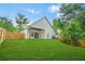 View of the home's back exterior featuring a covered patio and spacious backyard at 587 Woods Nw Dr, Atlanta, GA 30318
