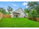 The backyard shows a well-maintained lawn with a covered patio area and sliding glass doors at 587 Woods Nw Dr, Atlanta, GA 30318