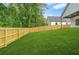 A spacious, well-manicured lawn is surrounded by a newly installed wooden privacy fence at 587 Woods Nw Dr, Atlanta, GA 30318