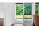 View of a backyard from the kitchen, with a patio, fence, and mature trees at 587 Woods Nw Dr, Atlanta, GA 30318