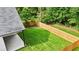 Aerial view of the backyard that features a new wooden fence and fresh green grass at 587 Woods Nw Dr, Atlanta, GA 30318