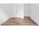 Bedroom features hardwood floors, white walls, closet with double doors, and a small doorway to another room at 587 Woods Nw Dr, Atlanta, GA 30318