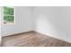 Bedroom featuring hardwood floors, white walls and trim, and a window at 587 Woods Nw Dr, Atlanta, GA 30318