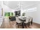Bright dining area featuring hardwood floors, modern lighting, and a view into the kitchen at 587 Woods Nw Dr, Atlanta, GA 30318