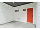 Inviting entrance featuring a vibrant orange door and modern white siding at 587 Woods Nw Dr, Atlanta, GA 30318
