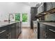 Stylish kitchen showcasing dark cabinetry, granite countertops, stainless steel appliances, and sliding glass doors at 587 Woods Nw Dr, Atlanta, GA 30318