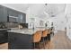 Modern kitchen features dark cabinets, black backsplash, granite countertop island, and hardwood flooring at 587 Woods Nw Dr, Atlanta, GA 30318
