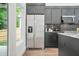 Well-equipped kitchen featuring stainless steel appliances, dark cabinets, and granite countertops at 587 Woods Nw Dr, Atlanta, GA 30318