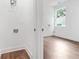 Laundry area with washer/dryer hookups next to a bedroom with hardwood floors at 587 Woods Nw Dr, Atlanta, GA 30318