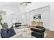 Cozy living room featuring a plush sofa, modern chairs, a glass coffee table, and sleek console at 587 Woods Nw Dr, Atlanta, GA 30318