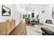Bright, open living room leads to a modern dining area, and features hardwood flooring throughout at 587 Woods Nw Dr, Atlanta, GA 30318
