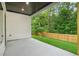 Covered patio featuring recessed lighting, and a view of the lawn and wooden privacy fence at 587 Woods Nw Dr, Atlanta, GA 30318