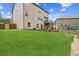 Expansive backyard showing the home's rear exterior and a lush green lawn perfect for Gathering and pets at 2755 Evan Manor Ln, Cumming, GA 30041